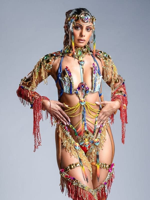 Model in a gold fringed and jewelled costume with a beaded headpiece