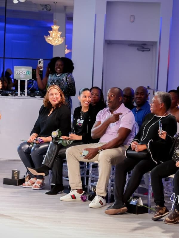 A presenter in a suit talking to people seated at an indoor launch event