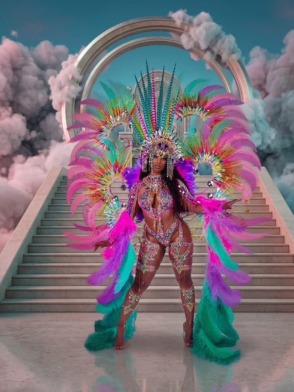 Halo costume: a model in pink, teal and gold feathers on a stairway into the clouds